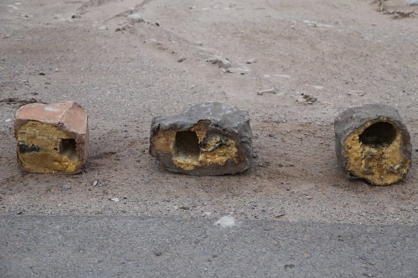 Three explosives disguised as rocks are on display in Yemen. Roadside bombs disguised as rocks in Yemen bear similarities to others used by Hezbollah in southern Lebanon and by insurgents in Iraq and Bahrain, suggesting at the least an Iranian influence in their manufacturing, according to a report by Conflict Armament Research (Tim Michetti/Conflict Armament Research via AP)