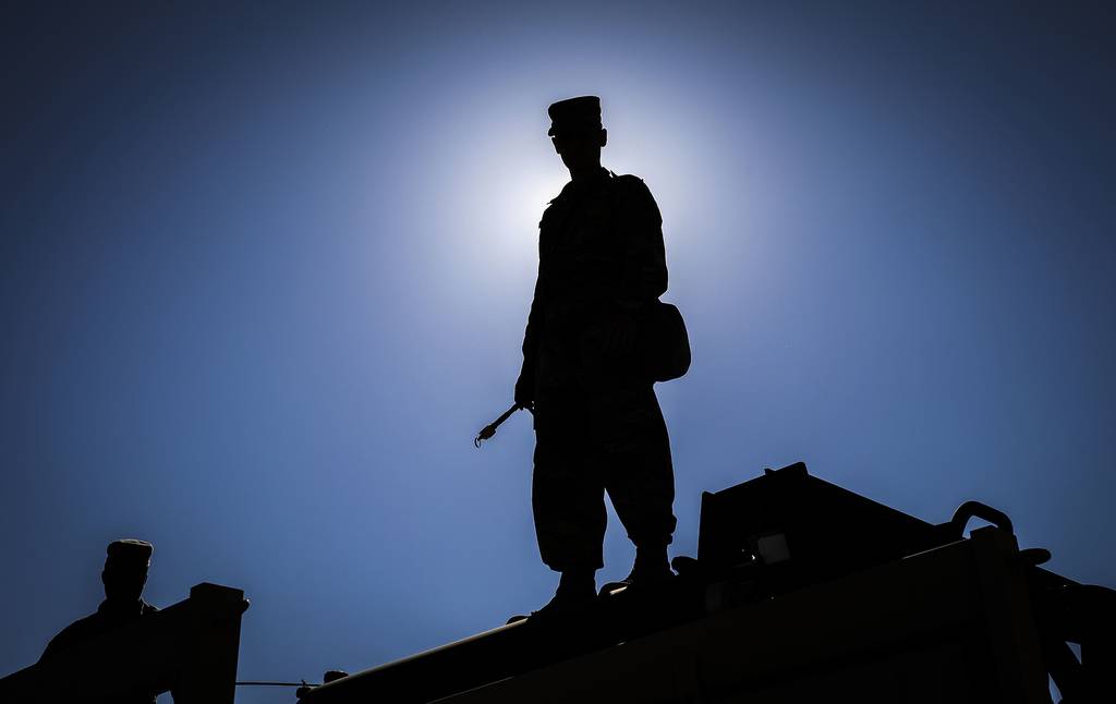 An Army Reserve sergeant stands on top of a vehicle and waits for his unit to begin a chemical decontamination mission at Dugway Proving Grounds, Utah, June 19, 2020.