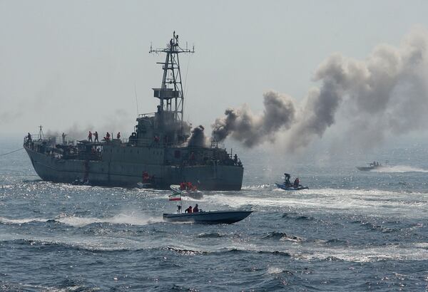 Members of Iran's Revolutionary Guard show their skills in attacking a naval vessel during military exercises in the Gulf on April 22, 2010. (Mehdi Marizad/AFP via Getty Images)