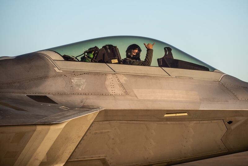 Cabo gestures from the cockpit of an F-22 Raptor. (Air Force)