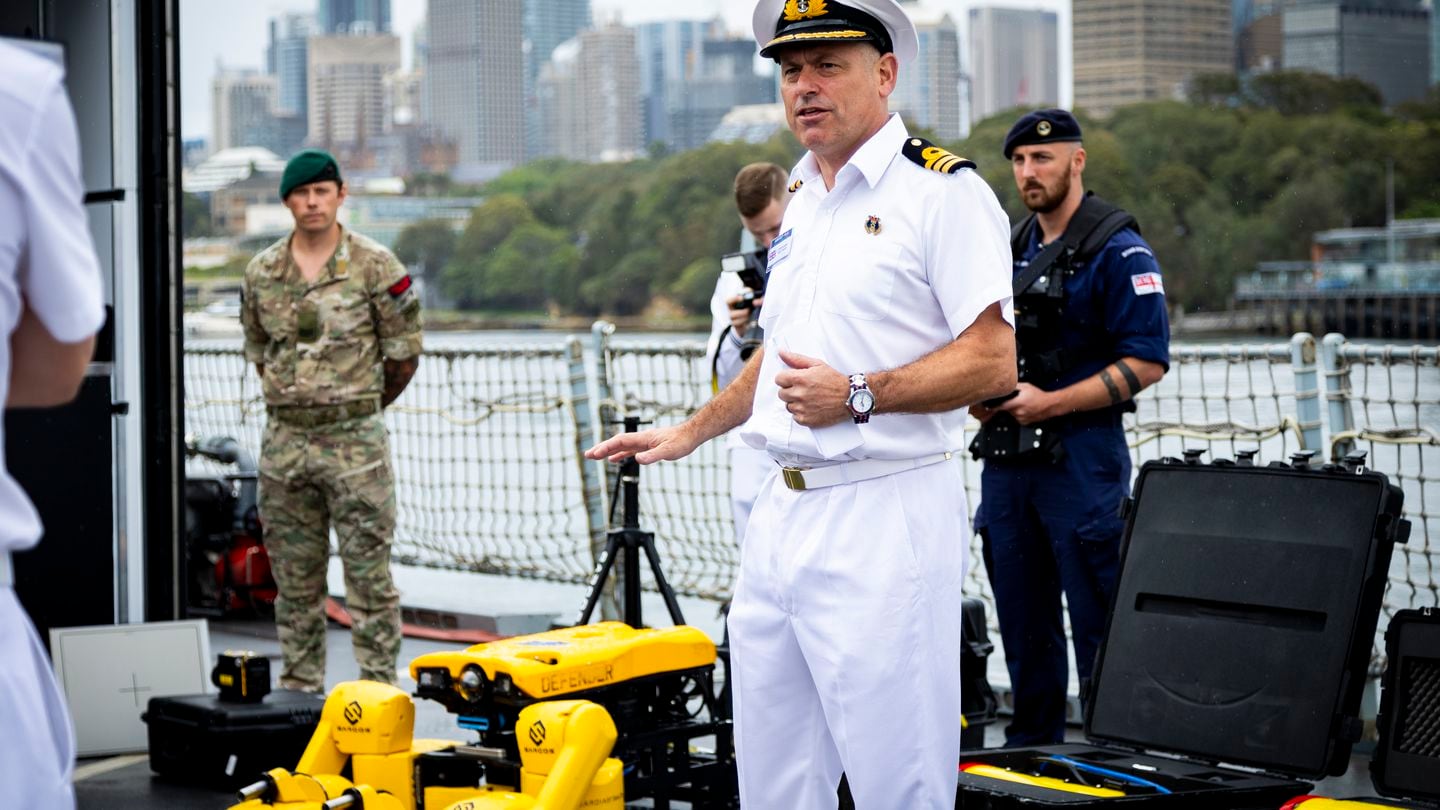 Commander Sean Heaton of the U.K. Royal Navy presents the capabilities used on board HMS Tamar during the Integrated Battle Problem 23.3 exercise near Sydney, Australia. The exercise tested a range of autonomous systems operating from the Royal Australian Navy's Mine Hunter Coastal HMAS Gascoyne, Undersea Support Vessel ADV Guidance and the UK's Off-Shore Patrol Vessel HMS Tamar. (LSIS David Cox/Royal Australian Navy)