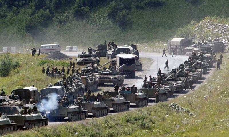 In this photo taken on Saturday, Aug. 9, 2008, a column of Russian armored vehicles head to Tskhinvali in the Georgian breakaway region of South Ossetia. (Musa Sadulayev, File/AP)