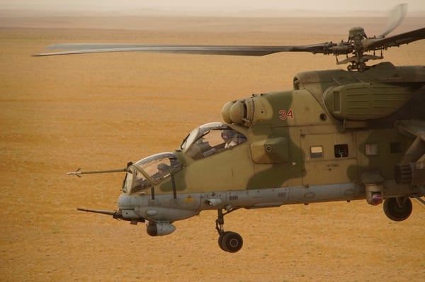 In this Friday, Sept. 15, 2017 photo Russian military helicopter flies over a desert in Deir es-Zor province, Syria. A U.S.-backed force in Syria said a Russian airstrike wounded six of its fighters Saturday near the eastern city of Deir el-Zour while in southeast Syria, Syrian troops and their Iran-backed allies began a new offensive aiming to capture areas along the Iraq border under the cover of Russian airstrikes. (AP Photo)