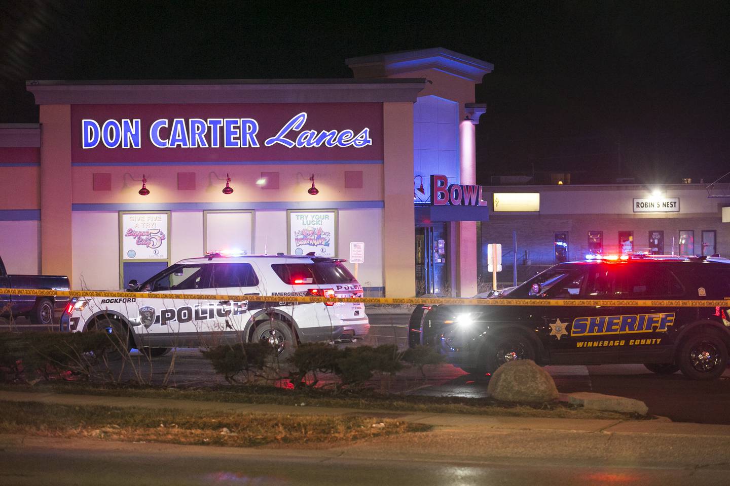 Rockford police and other law enforcement agencies investigate the scene of a shooting at a bowling alley Saturday, Dec. 26, 2020, in Rockford, Ill.