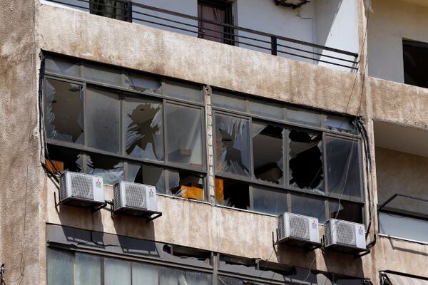 Broken windows are seen on the 11-floor building that houses the media office in a stronghold of the Lebanese Hezbollah group in a southern suburb of Beirut, Lebanon, Sunday, Aug. 25, 2019. (Bilal Hussein/AP)