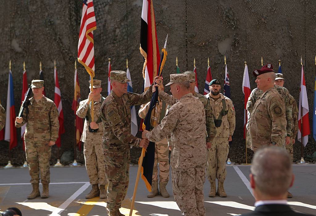 In this Sept. 14, 2019, file photo U.S. Army Lt. Gen. Pat White, III Armored Corps commanding general, center left, and Gen. Kenneth F. McKenzie Jr., commanding general for U.S. Central Command,  center right, take part in a transfer authority ceremony at Union III, base in Baghdad, Iraq.