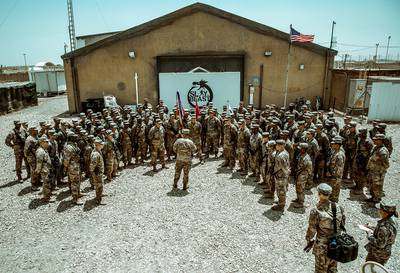 Maj. Gen. Flem B. "Donnie" Walker, commanding general of 1st Theater Sustainment Command, speaks with Task Force Cavalier Soldiers of the 529th Support Battalion, 574th Quartermaster Company, and 183d Maintenance Company at Camp Taji, Iraq, June 8, 2019.