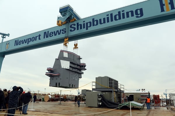 The 555-metric-ton island for the future nuclear-powered aircraft carrier Gerald R. Ford is lifted into position on the ship’s flight deck at Huntington Ingalls Industries-Newport News Shipbuilding on Jan. 26, 2013. (MC3 Sabrina Fine/U.S. Navy)