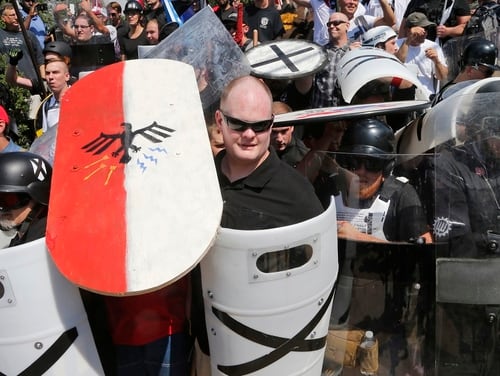 In this Aug. 12, 2017, file photo, white nationalist demonstrators use shields as they guard the entrance to Lee Park in Charlottesville, Va. The latest Military Times Poll of active-duty troops found that more than 1 in 3 have seen signs of white supremacist or similarly extremist ideology in the ranks, an increase from last year's survey. (Steve Helber/AP)