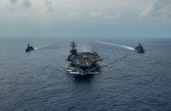 The aircraft carrier Ronald Reagan, the cruiser Chancellorsville and the Akizuki class destroyer Fuyuzuki from the Japan Maritime Self Defense Force sail in formation while conducting a bilateral exercise in the Philippine Sea on Oct. 27. (Navy photo by: MC3 Codie Soule)