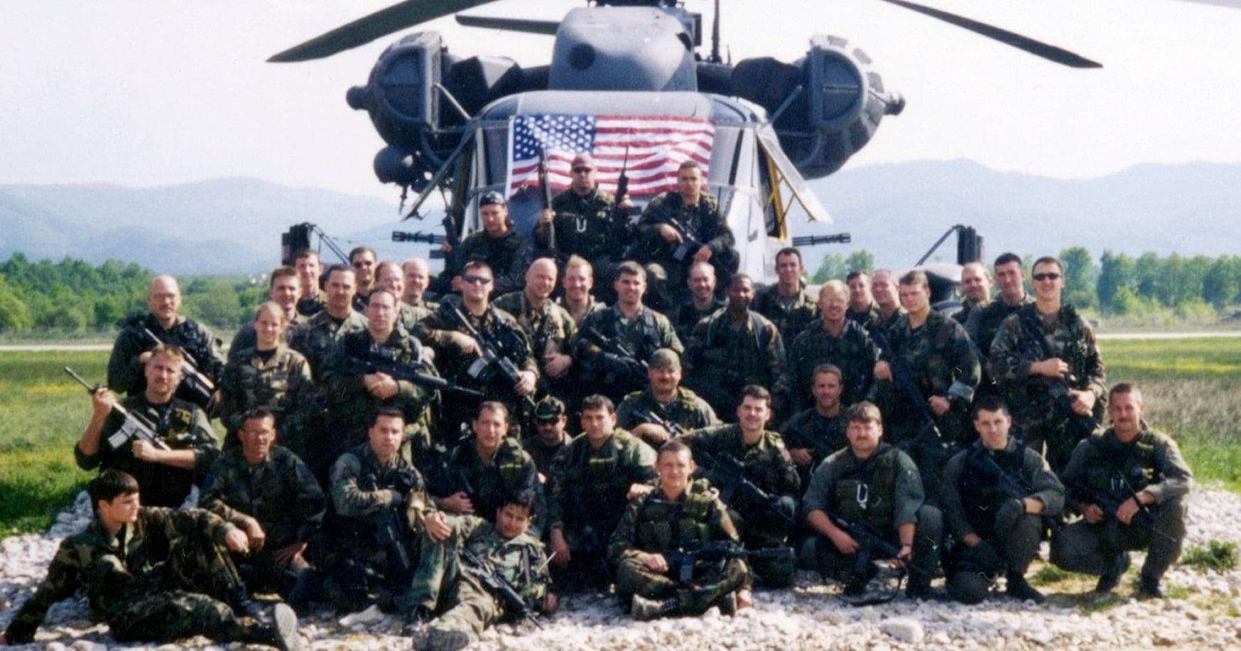 Special operations soldiers and airmen who took part in Goldfein's rescue pose in front of a helo at Tuzla Air Base, Bosnia. (Air Force)