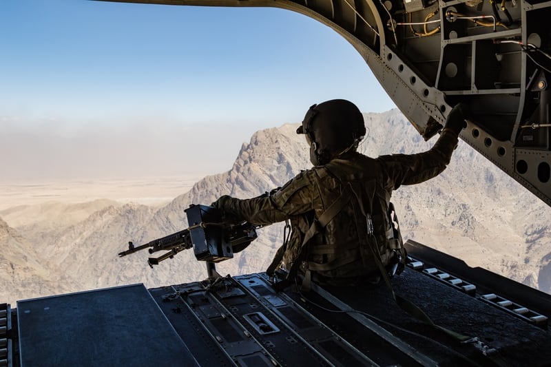 A U.S. Army CH-47 Chinook helicopter crew chief assigned to Task Force Flying Dragons, 16th Combat Aviation Brigade, 7th Infantry Division scans below during a flight near Jalalabad, Afghanistan, June 12, 2017. (Army)