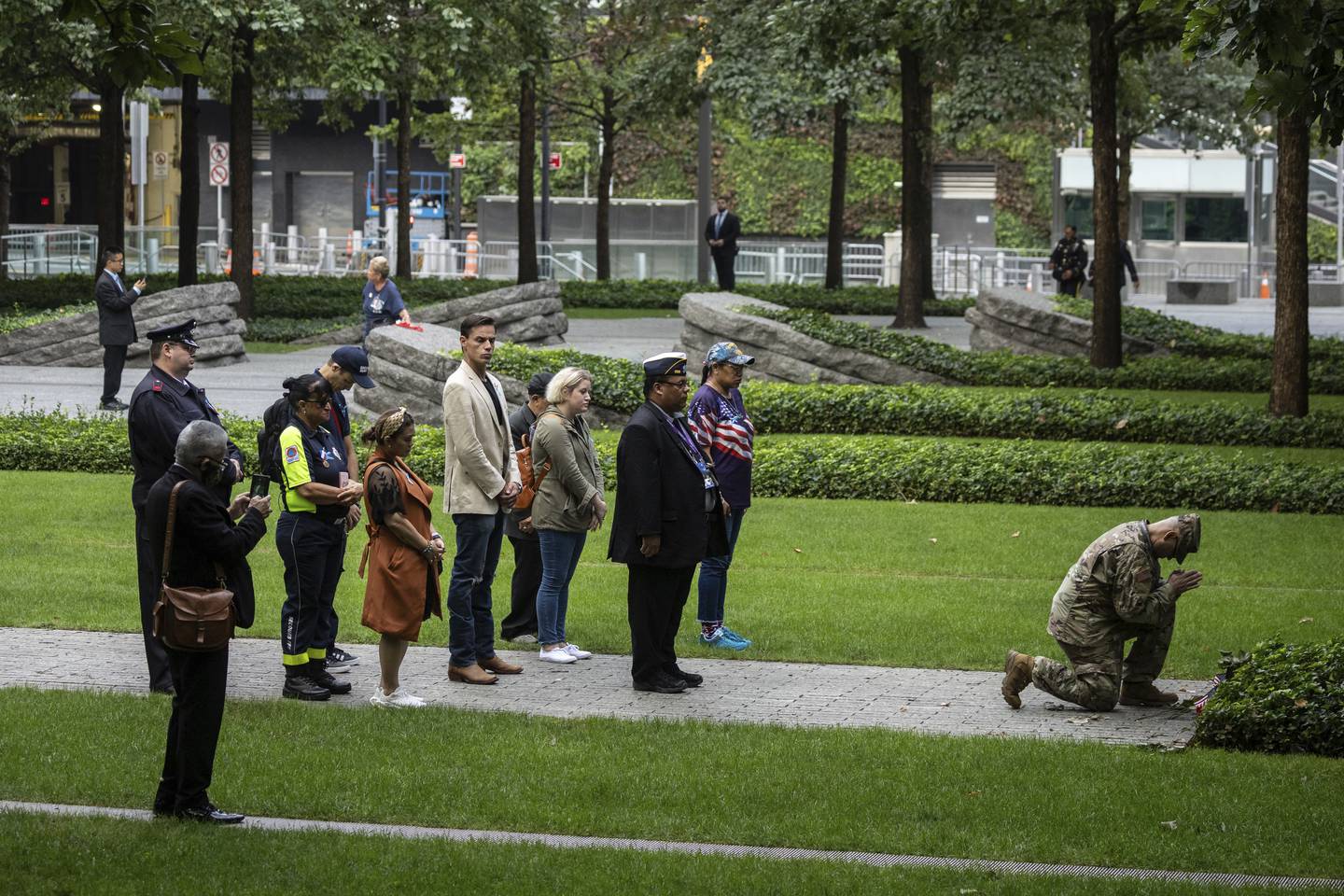 People pray before the commemoration ceremony on the 22nd anniversary of the September 11, 2001, terror attacks on Monday, Sept. 11, 2023, in New York.