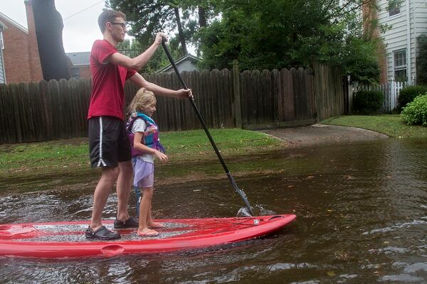 Eric Young paddles through flooded streets in Larchmont with his daughter, Emily Ruth, 5, after Hurricane Dorian brought heavy wind and rain to Norfolk on Friday. (Kaitlin McKeown/The Virginian-Pilot via AP)