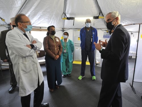 VA Secretary Denis McDonough speaks Michael Heimall, director of the Washington, D.C. VA Medical Center, during a tour of the facility's COVID-19 Vaccination tent on Feb. 10, 2021. (Robert Turtil/Department of Veterans Affairs)