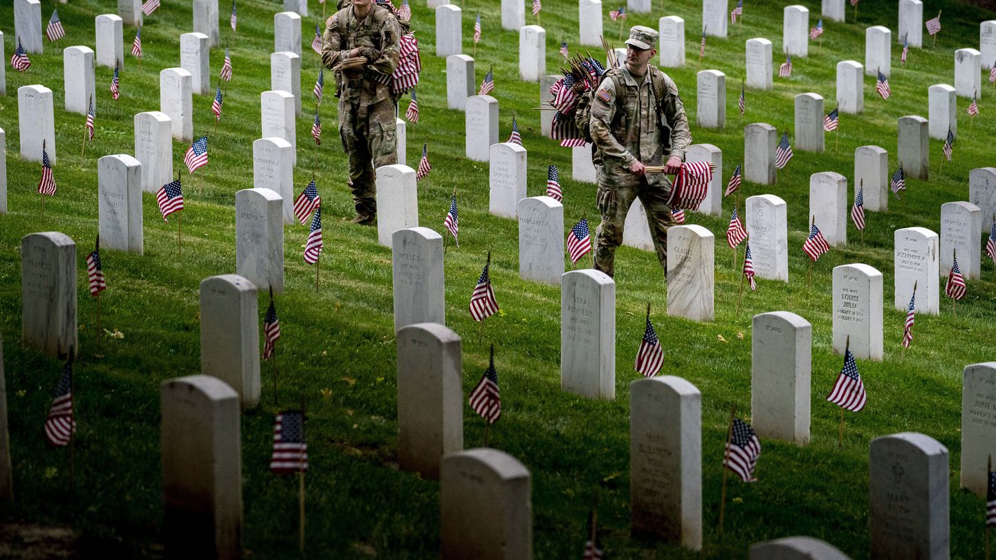 Members of the 3rd U.S. Infantry Regiment also known as The Old Guard place flags in front of each headstone for 
