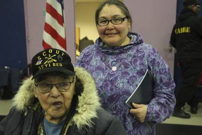 This March 28, 2023, photo shows Bruce Boolowon, left, posing with his eldest daughter, Rhona Pani Apassingok, at an Alaska National Guard ceremony in Gambell, Alaska.