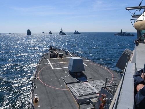 A sailor takes in the view from the front of the Arleigh Burke-class guided-missile destroyer Bainbridge (DDG 96) as the ship is positioned for a photo exercise during BALTOPS, June 9, 2018. (Theron J. Godbold/ Navy)