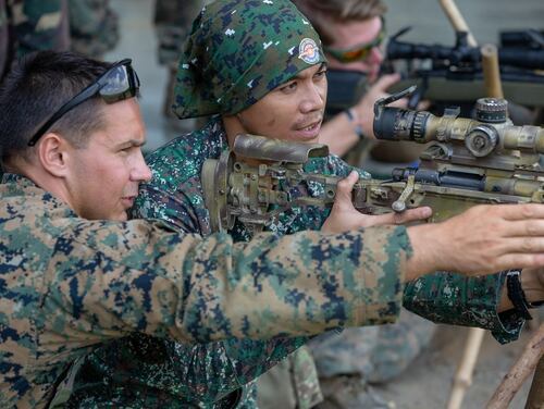 U.S. Marine Lance Cpl. Zachary Johnson shares his knowledge of the M40A6 sniper rifle with a Philippine Marine during KAMANDAG 3 at Fort Magsaysay, Philippines, Oct. 14, 2019. (Lance Cpl. Ujian Gosun/Marine Corps)
