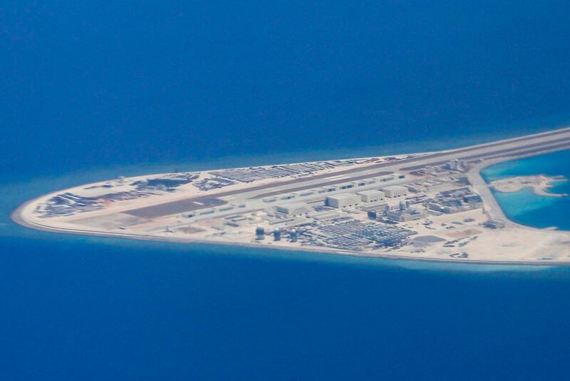 In this April 21, 2017, file photo, Chinese structures and an airstrip on the man-made Subi Reef at the Spratly group of islands in the South China Sea are seen from a Philippine Air Force C-130. (Francis Malasig/Pool Photo via AP)