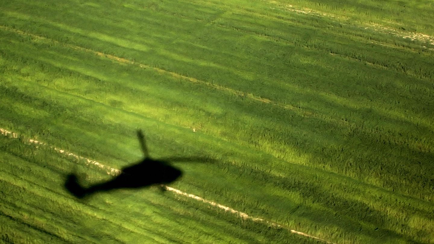The shadow of a U.S. Black Hawk helicopter is cast on a field as it flies over an area in al-Dor north of Baghdad, Iraq. (Karim Sahib/AFP via Getty Images)
