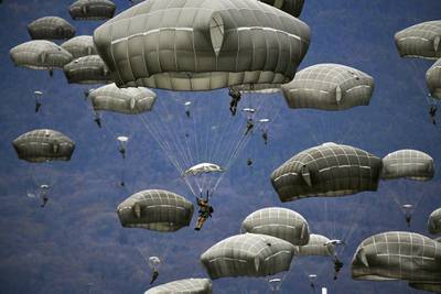 U.S. Army and Italian Army paratroopers conduct airborne operation after exiting a U.S. Air Force C-130 Hercules aircraft at Juliet Drop Zone, Pordenone, Italy, Dec. 10, 2020.