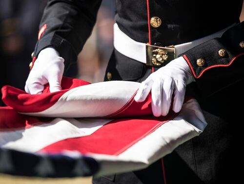 A U.S. Marine folds the American flag during the funeral of a Marine in 2019. (Cpl. Tessa D. Watts/Marine Corps)