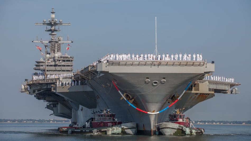 Norfolk, Va. (Aug. 21, 2017) The aircraft carrier George H.W. Bush is guided by tug boats alongside Pier 14 at Naval Station, Norfolk, Va. after returning from 212-day deployment, which saw them spend 99 day 