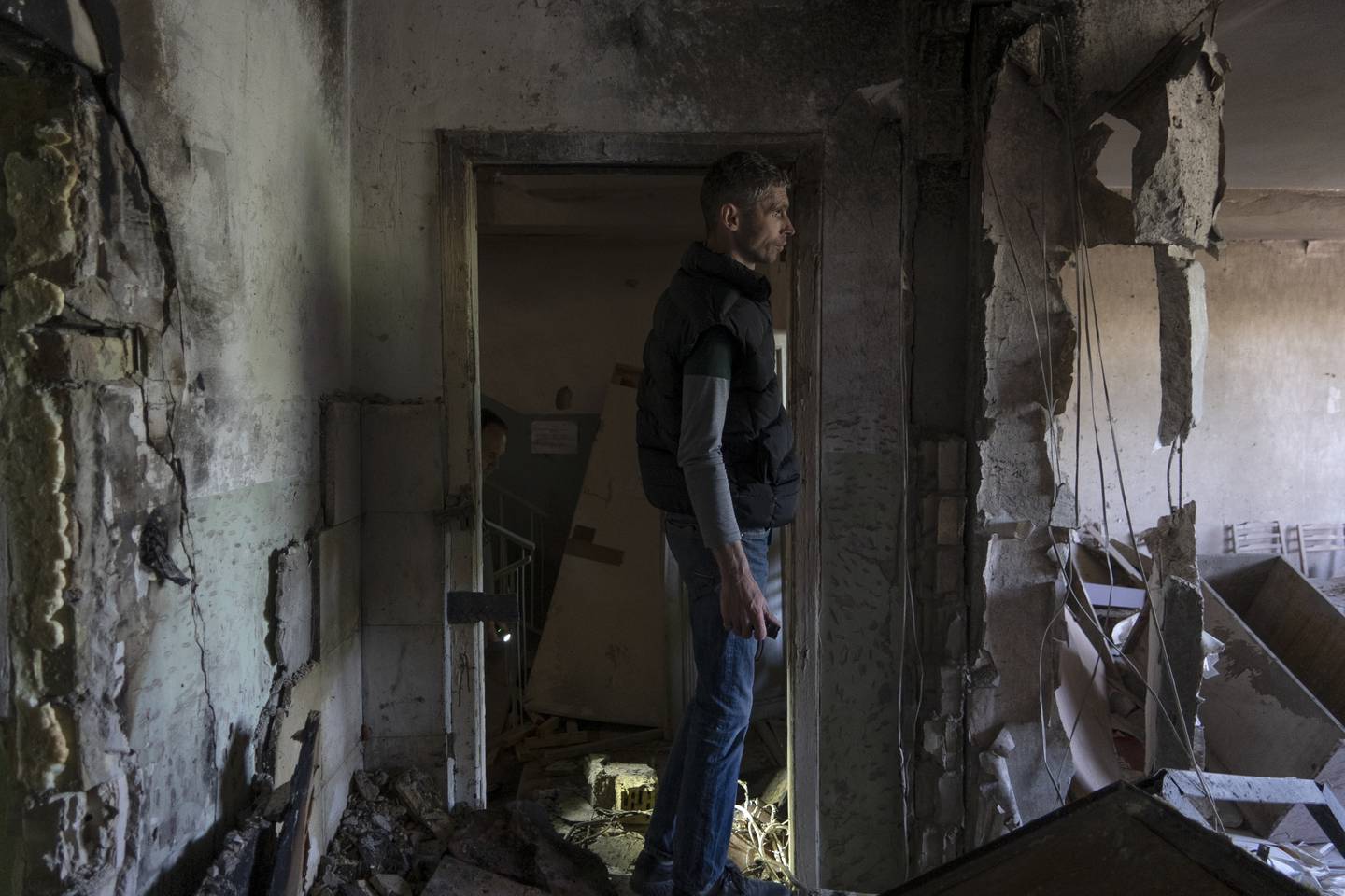 A man inspects his office damaged by a drone during a night attack, in Kyiv, Ukraine, Sunday, May 28, 2023.