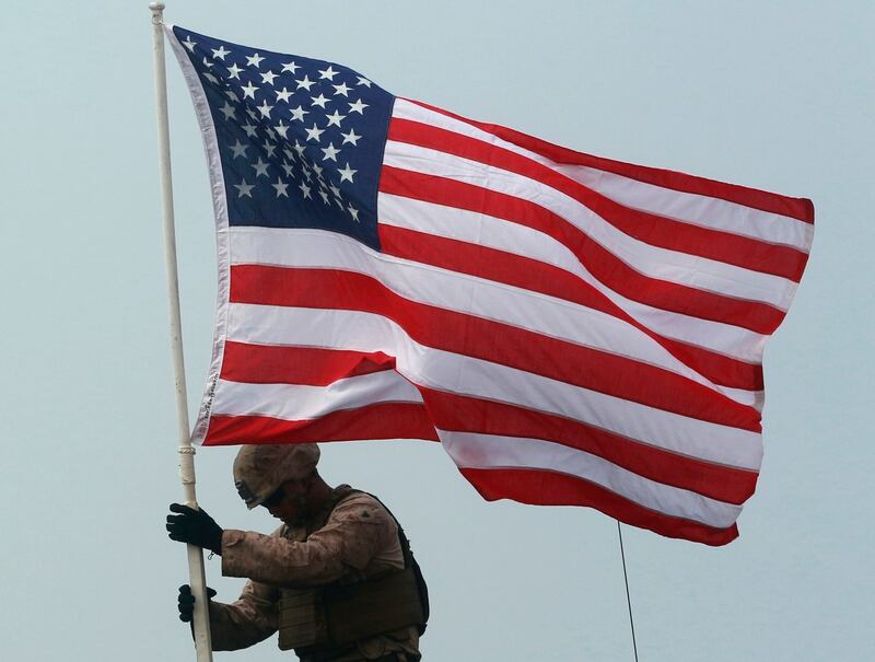 A U.S. Marine raising the American flag on an amphibious assault vehicle during the ongoing Cobra Gold U.S.-Thai joint military exercise on Hat Yao beach in Chonburi province, eastern Thailand, Saturday, Feb. 17, 2018. Approximately 11,000 military personnel from the U.S., Thailand, and South Korea are taking part in the annual drill. (Sakchai Lalit/AP)