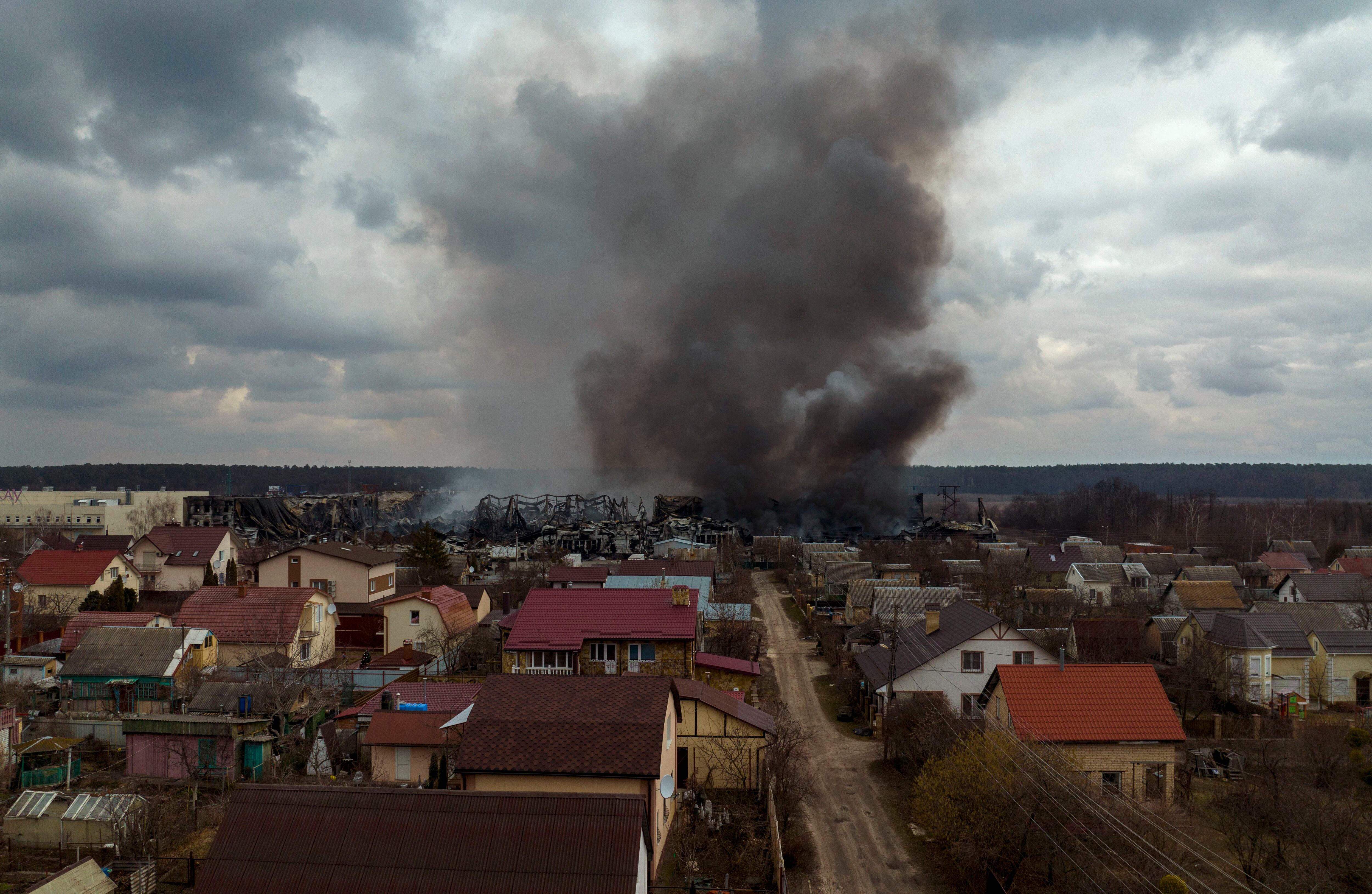 A factory and a store burn after being bombarded in Irpin, on the outskirts of Kyiv, Ukraine, Sunday, March 6, 2022. (Emilio Morenatti/AP)