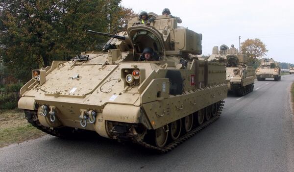 Members of the US Army drive Bradley Fighting Vehicles from the railway station near the Rukla military base in Lithuania on Oct. 4, 2014. The $700 billion defense budget for fiscal 2018 approved by lawmakers Friday includes big increases in equipment procurement and modernization. (Petras Malukas/Getty Images)