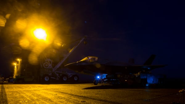 U.S. Marines with Marine Fighter Attack Squadron 211, 13th Marine Expeditionary Unit, load ordnance into an F-35B Lightning II aboard the amphibious assault ship Essex in preparation for the F-35B's first combat strike Sept. 27 (Cpl. A J. Van Fredenberg/Marine Corps)