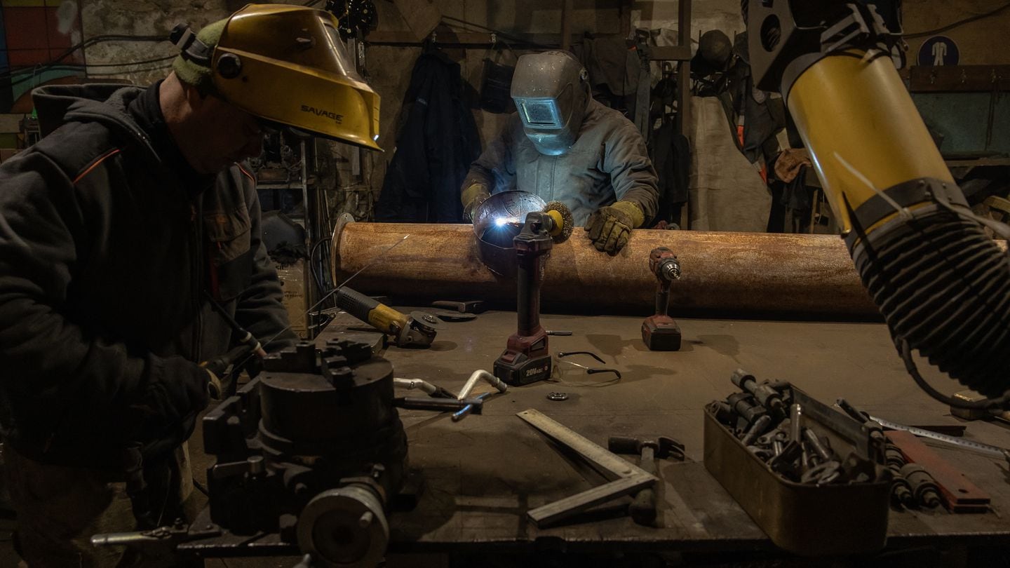 Ukrainian welders of the 24th Brigade work at a workshop for repairing military vehicles, in the Donetsk region, on January 25, 2024, amid the Russian invasion of Ukraine. (Photo by Roman PILIPEY / AFP) (Photo by ROMAN PILIPEY/AFP via Getty Images)