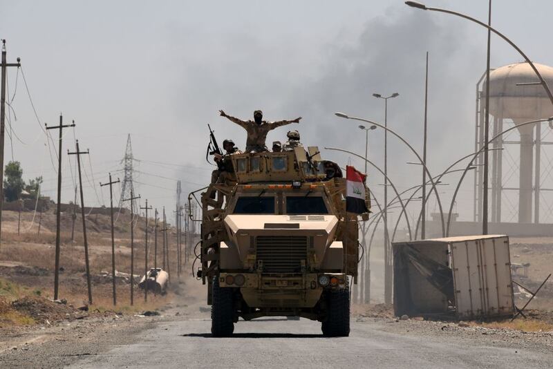 Iraqi government forces drive on a road leading to Tal Afar on June 9, 2017, during ongoing battles to retake the city from Islamic State fighters. (Mohamed El-Shahed/AFP/Getty Images) 