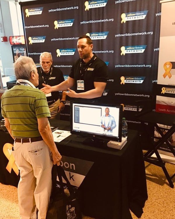 John Pickens (L), executive director of VeteransPlus and the Yellow Ribbon Network, and Kyle Vanschoyck (R), director of the Yellow Ribbon Network, speak with a veteran at a Homeless Veterans Outreach event in Florida. (Photo provided by John Pickens)