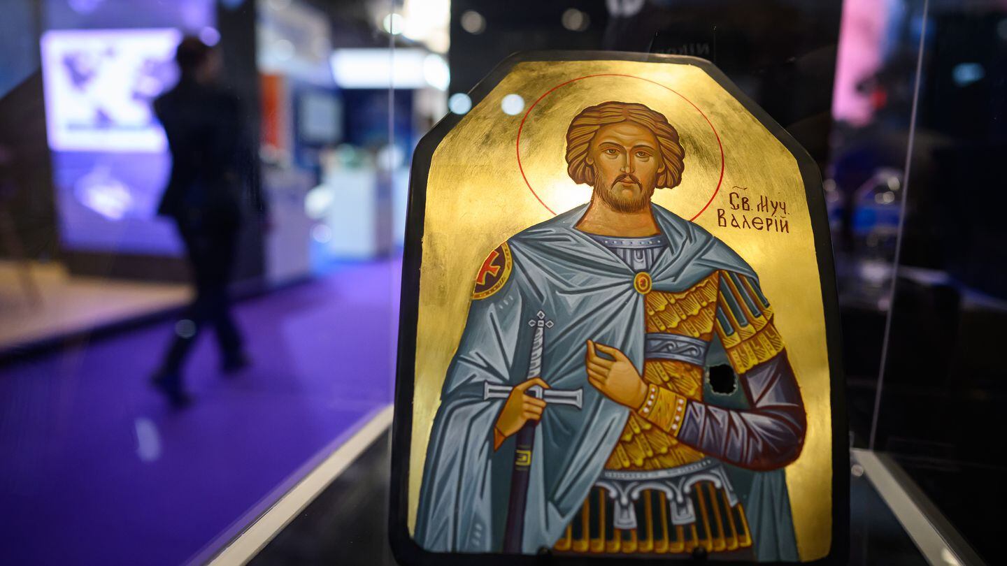 A decorated armor plate, produced by NP Aerospace, that saved the life of a soldier in Ukraine is seen Sept. 12, 2023, during the DSEI fair in London, England. Featuring a painting of Saint Valerius, the plate is one of a number of similar items to be auctioned in the British city in early 2024. (Leon Neal/Getty Images)
