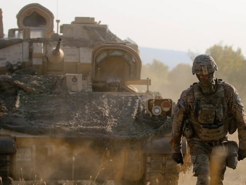 U.S. Army Sgt. 1st Class Chez Carter, assigned to Alpha Company, 2nd Battalion, 5th Cavalry Regiment, 1st Armored Brigade Combat Team, 1st Cavalry Division ground guides a M2A3 Bradley Fighting Vehicle during a Table XII Live Fire Exercise, Novo Selo Training Area, Bulgaria, August 23, 2018. This exercise is in support of Atlantic Resolve, an enduring training exercise between NATO and U.S. Forces. (U.S. Army National Guard photo by Sgt. Jamar Marcel Pugh, 382nd Public Affairs Detachment/ 1st ABCT, 1st CD/Released)