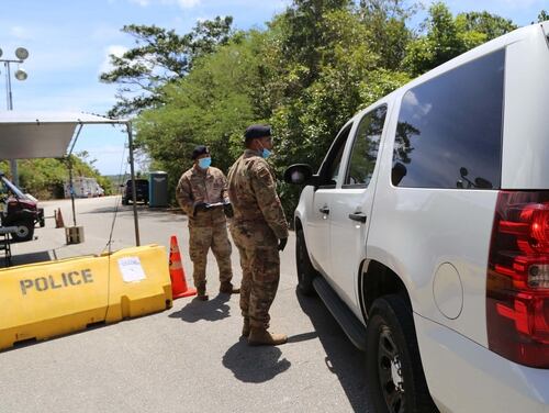 Senior Airman Keith Orlino, left, and Tech. Sgt. Shawn Morrison, right) of the Guam Air National Guard provide security support at a COVID-19 isolation facility in Barrigada, Guam, on March 23.(JoAnna Delfin/Army National Guard)