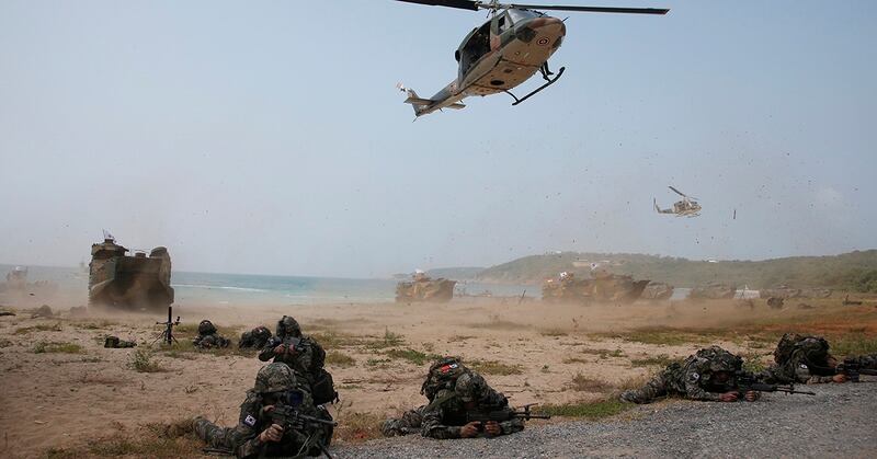 South Korea soldiers take their position front an amphibious assault vehicle after landing during the ongoing Cobra Gold U.S.-Thai joint military exercise on Hat Yao beach in Chonburi province, eastern Thailand, Saturday, Feb. 17, 2018. Approximately 11,000 military personnel from the U.S., Thailand, and South Korea are taking part in the annual drill. (Sakchai Lalit/AP)