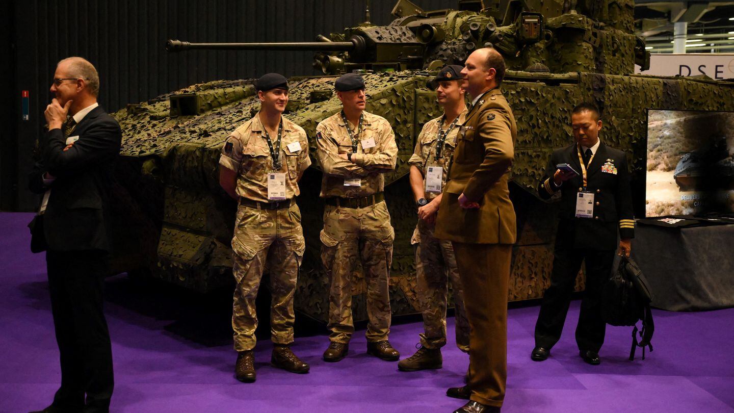 Members of the British Army stand by a tank during the DSEI trade show in London on Sept. 12, 2023. (Daniel Leal/AFP via Getty Images)