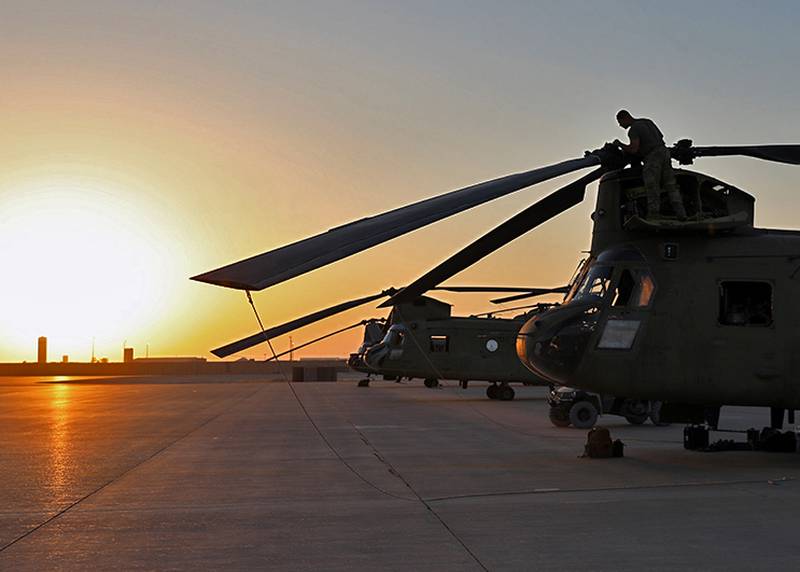 U.S. Army soldiers conduct preflight checks and load cargo onto CH-47 Chinooks Aug. 27, 2023, at al-Asad air base, Iraq.