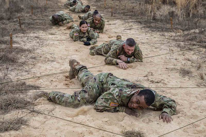 Army Medicine sergeants major low crawl during an obstacle course validation exercise on Fort Gordon, Ga., Jan. 21, 2021, ahead of the Army Best Medic Competition (ABMC). The ABMC will take place from Jan. 25-28 at Fort Gordon.