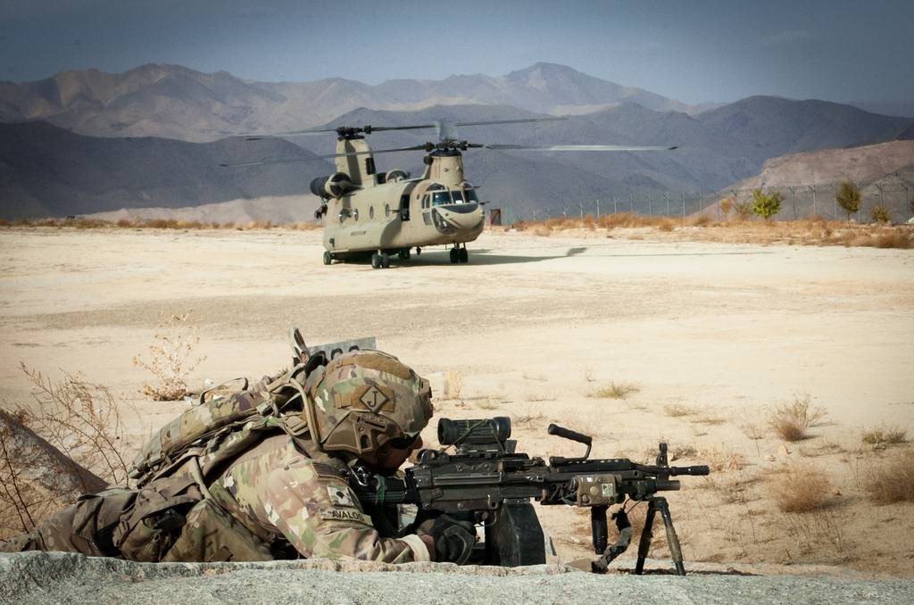 A paratrooper from 1st Battalion, 505th Parachute Infantry Regiment, 3rd Brigade Combat Team, 82nd Airborne Division secures a helicopter landing zone as a CH-47 Chinook helicopter prepares to take off on Oct. 21, 2019, in Daykundi Province, Afghanistan.