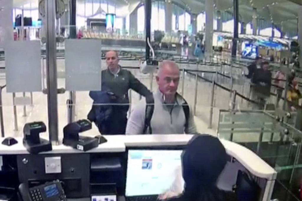 This Dec. 30, 2019, image from security camera video shows Michael L. Taylor, center, and George-Antoine Zayek at passport control at Istanbul Airport in Turkey.