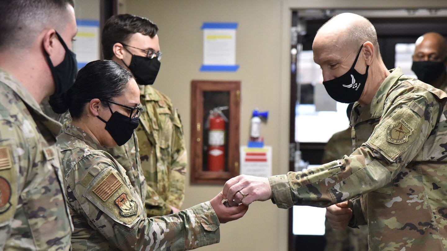 Gen. David Allvin, Air Force vice chief of staff, presents a coin for exceptional performance to Tech Sgt. Mayra Corona, 341st Medical Group MHS Genesis project coordinator, during a trip to Malmstrom Air Force Base, Mont., in January 2021. (Senior Airman Daniel Brosam/Air Force)