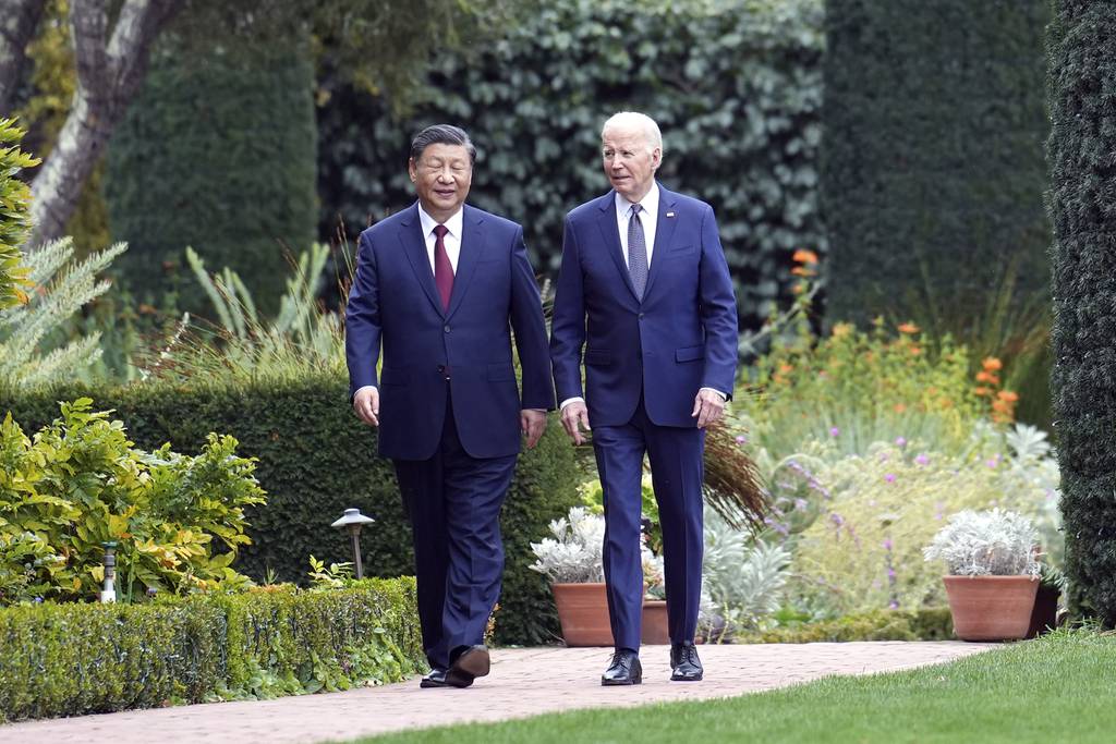 President Joe Biden and China's President President Xi Jinping walk in the gardens at the Filoli Estate in Woodside, Calif., Wednesday, Nov, 15, 2023, on the sidelines of the Asia-Pacific Economic Cooperative conference.
