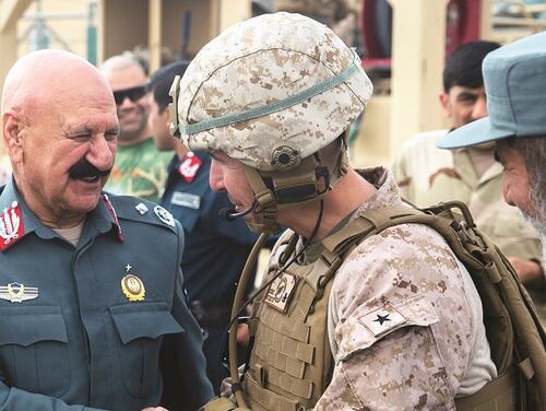 Insurgents control or influence over 14 percent of Afghanistan's 407 districts. Pictured: The deputy commander of the 505th Zone Afghan National Police and U.S. Marine Brig. Gen. Benjamin Watson, commanding general of Task Force Southwest, exchange words before Watson departs Bost Airfield, Afghanistan, after a shura, March 13, 2018. (Staff Sgt. Melissa Karnath/Marine Corps)