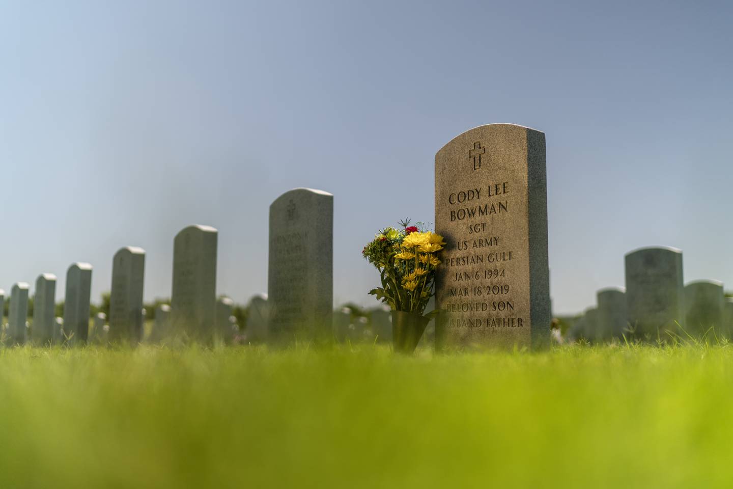 The tombstone of Army Sgt. Cody Bowman stands at the Dallas-Fort Worth National Cemetery, Sunday, June 11, 2023, in Dallas.