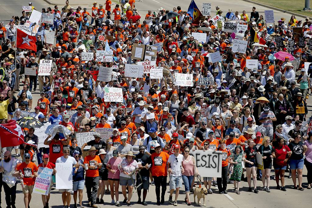 In this July 20, 2019, file photo, protesters march outside Fort Sill in protest of plans to place migrant children at the Army post in Lawton, Okla.